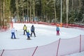Skating children learning skiing together