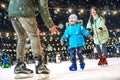 Skating rink. Happy family on the ice rink.