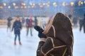 Skating rink. Woman takes photo on smartphone Royalty Free Stock Photo