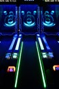 Skee-Ball Arcade Game Lit Up with Neon Lights Royalty Free Stock Photo