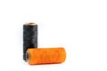 A skein of black and orange thread. Coils of colored threads on a white background. Waxed sewing thread for leather