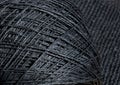 A skein of black raffia on a black background