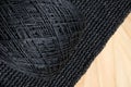 The skein of black raffia on a crochet raffia pattern Royalty Free Stock Photo