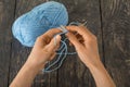 Skein of blue yarn and knitting needles. Hand made on dark surface Royalty Free Stock Photo