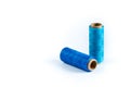 A skein of cyan and blue thread. Coils of colored threads on a white background. Waxed sewing thread for leather goods.