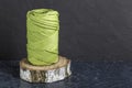 A skein of green cotton cord, consisting of threads twisted together