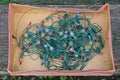 A skein of an old green electric Christmas garland with small colored light bulbs