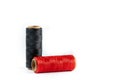 A skein of red and black thread. Coils of colored threads on a white background. Waxed sewing thread for leather goods.