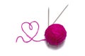Skein of wool pink with spokes and thread in the shape of a heart on a white background Royalty Free Stock Photo