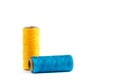 A skein of yellow and cyan thread. Coils of colored threads on a white background. Waxed sewing thread for leather goods