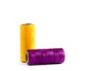 A skein of yellow and purple thread. Coils of colored threads on a white background. Waxed sewing thread for leather