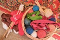 Skeins of thread with combs in a basket, close-up. Sewing tools, wooden sticks for knitting
