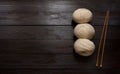 Skeins and wooden knitting needles on a brown wooden table.