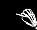 Skeletal hand writes on a blackboard Royalty Free Stock Photo