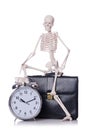 Skeleton with alarm clock on the white