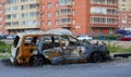 The skeleton of a burnt-out passenger car on the street