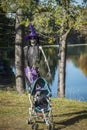 Skeleton dressed as a witch walking his baby