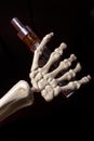 Skeleton hand holding an ecigarette with ejuice in it Royalty Free Stock Photo