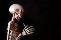 Skeleton holding an ecigarette with danger red highlights ready to vape