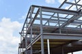 Skeleton of metal building under construction is shown Royalty Free Stock Photo