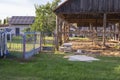 The skeleton of an old, destroyed barn being demolished on a sunny day. Grass