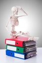 Skeleton with pile of files against gradient Royalty Free Stock Photo