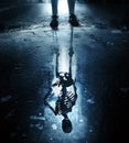 Skeleton reflection in puddle Royalty Free Stock Photo