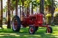 Skeleton sits behind the wheel of a red tractor during the Halloween season