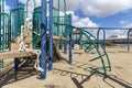 Skeleton sitting on childs toy at an empty closed park on a nice day Royalty Free Stock Photo