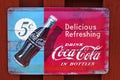 An old billboard for a famous soft drink company