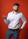 Skeptic annoyed young bearded business man gesturing in white sh