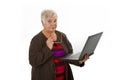 Skeptic female senior with laptop