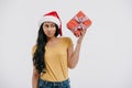 skeptical african american girl in santa hat holding present Royalty Free Stock Photo