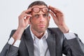 Skeptical businessman with eyeglasses on his forehead for suspicion Royalty Free Stock Photo