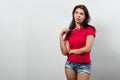 Skeptical. Closeup portrait confused skeptical woman posing, holding glasses near her mouth looking at you camera skeptically Royalty Free Stock Photo