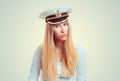 Skeptical woman in captain hat looking doubtful at you camera Royalty Free Stock Photo