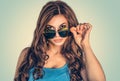 Skeptical woman hold sunglasses looking at camera