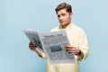 skeptical young man in shirt reading Royalty Free Stock Photo