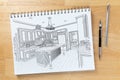 Sketch Pad on Desk with Drawing of Custom Kitchen Interior Next To Engineering Pencil and Ruler Scale