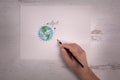 Sketch of world with cartoonish airplane flying around the earth