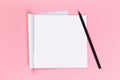 Top view of blank open notebook on pink background, concept of education or new workplace Royalty Free Stock Photo