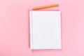 Top view of blank open notebook on pink background, concept of education or new workplace Royalty Free Stock Photo