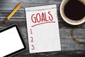 Sketchbook with tablet, pen, cup of coffee and personal goals checklist Royalty Free Stock Photo