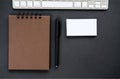 A sketchpad with brown pages and empty business cards