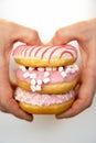 A sketchy plan of a variety of donuts in the hands of a man on a white background. sweet pastries