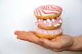 A sketchy plan of a variety of donuts in the hands of a man on a white background. sweet pastries