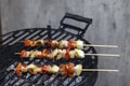 skewer with red pepper onion and smoked pork on a garden grill