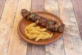 Skewer of veal meat skewered with onion and vegetables marinated in sauce