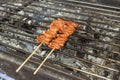 Skewered Chicken small intestine, or locally known in the Philippines as isaw, being cooked on a charcoal grill