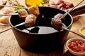 Skewered meat chunks and pot of sauce Royalty Free Stock Photo